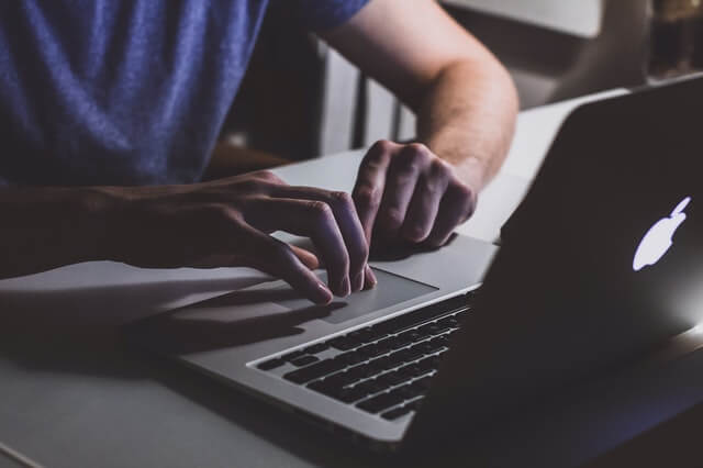 Developer working at a desk with code on screen